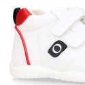 White color OKAA FLEX tennis kids shoes laceless and with toe cap.