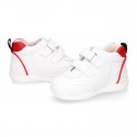 White color OKAA FLEX tennis kids shoes laceless and with toe cap.