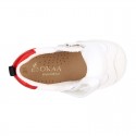 White color OKAA FLEX tennis kids shoes laceless and with toe cap.