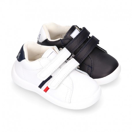 Washable leather OKAA Little kids School tennis shoes laceless and with side flag design.