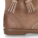 Classic kids suede leather boots with TASSELS and FAKE HAIR POMPONS design.