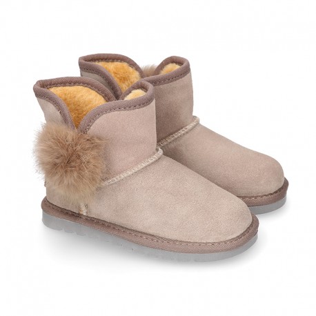 Suede leather Australian style Boot shoes with POMPOM design and fake hair lining.