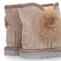 Suede leather Australian style Boot shoes with POMPOM design and fake hair lining.