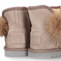 Suede leather Australian style Boot shoes with POMPOM design and fake hair lining.