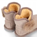 Suede leather Australian style Boot shoes with POMPOM design and fake hair lining.