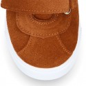 Suede leather OKAA Kids Sneaker or Tenis style shoes with double hook and loop strap closure in autumn colors.