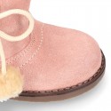 Little ankle boot shoes with FAKE HAIR lining and POMPOMS design in suede leather for first steps.