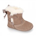 Baby girl bootie with BOW, hook and loop strap closure in suede leather.