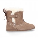 Baby girl bootie with BOW, hook and loop strap closure in suede leather.