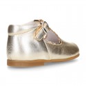 Classic Kids Laminated Nappa leather T-strap shoes with buckle fastening.