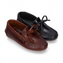 Tanned leather kids moccasins shoes with ties design in CLASSIC COLORS.