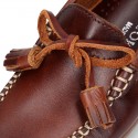 Tanned leather kids moccasins shoes with ties and TASSELS design.