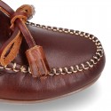 Tanned leather kids moccasins shoes with ties and TASSELS design.