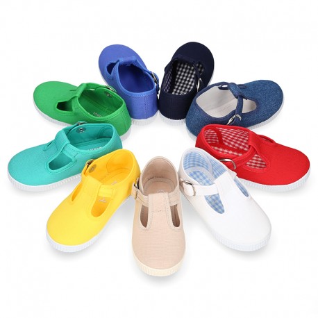 Cotton Canvas T-strap shoes with buckle fastening.