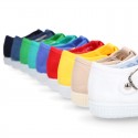 Cotton Canvas T-strap shoes with buckle fastening.