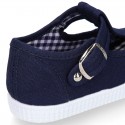 Cotton Canvas T-strap shoes with buckle fastening.