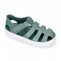 SNEAKER style kids jelly shoes with hook and loop strap in solid colors.