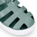 SNEAKER style kids jelly shoes with hook and loop strap in solid colors.