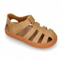 SNEAKER style kids jelly shoes with hook and loop strap in solid colors and caramel soles.