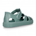 SNEAKER style kids jelly shoes with hook and loop strap in solid colors and matching soles.