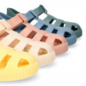 SNEAKER style kids jelly shoes with hook and loop strap in solid colors and matching soles.