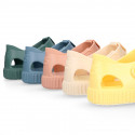 SNEAKER style kids jelly shoes with hook and loop strap in solid colors and matching soles.