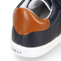 Navy blue color OKAA FLEX tennis kids shoes laceless combined with tan color.