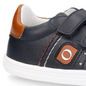 Navy blue color OKAA FLEX tennis kids shoes laceless combined with tan color.