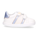 White color OKAA FLEX girl tennis shoes laceless with silver color stripes design.