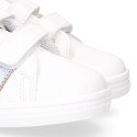 White color OKAA FLEX girl tennis shoes laceless with silver color stripes design.