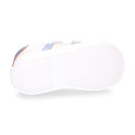 White color OKAA FLEX girl tennis shoes laceless with silver color stripes design.