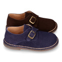 Suede leather Oxford shoes with buckle fastening for kids.