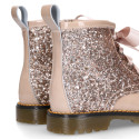 ROCK style patent leather kids boots with GLITTER and fur design and ties closure.