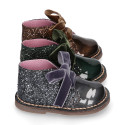 Girl GLITTER and pearl patent leather safari boots with velvet ties closure.