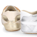 Baby sneaker with hook-and-loop closure in laminated leather.