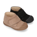 Suede leather Kids ankle boots laceless and with toe cap design.