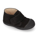 Suede leather Kids ankle boots laceless and with toe cap design.