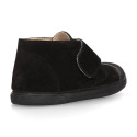 Suede leather Kids ankle boots laceless and with toe cap design.