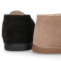 Suede leather Kids ankle boots laceless and with toe cap design.