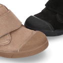 Suede leather Kids ankle boots laceless and with toe cap design.