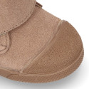 Suede leather Kids ankle boots laceless and with toe cap design.