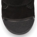 Suede leather Kids ankle boots laceless and with toe cap design.