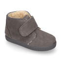 Suede leather little bootie sneaker style with fake hair lining and laceless in fall colors.