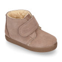 Suede leather little bootie sneaker style with fake hair lining and laceless in fall colors.