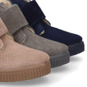 Suede leather little bootie sneaker style with fake hair lining and laceless in fall colors.