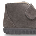 Suede leather little bootie sneaker style with fake hair lining and laceless in fall colors.