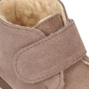 Suede leather little bootie sneaker style with fake hair lining and laceless in fall colors.