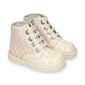 ROCK style BEIGE patent leather girl boots with metal ties closure.