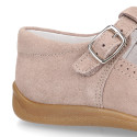 Classic suede leather T-strap shoes with toe cap and buckle fastening.