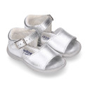 Metal finish leather sandals with buckle fastening and super flexible soles for little girls.